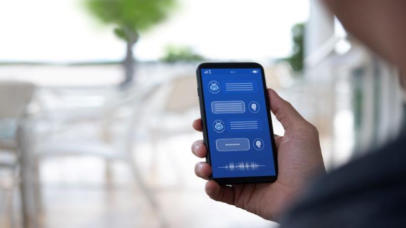 Man holding phone with chatbot on screen