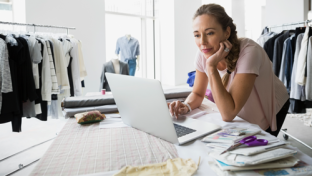 woman smiling in front of laptop